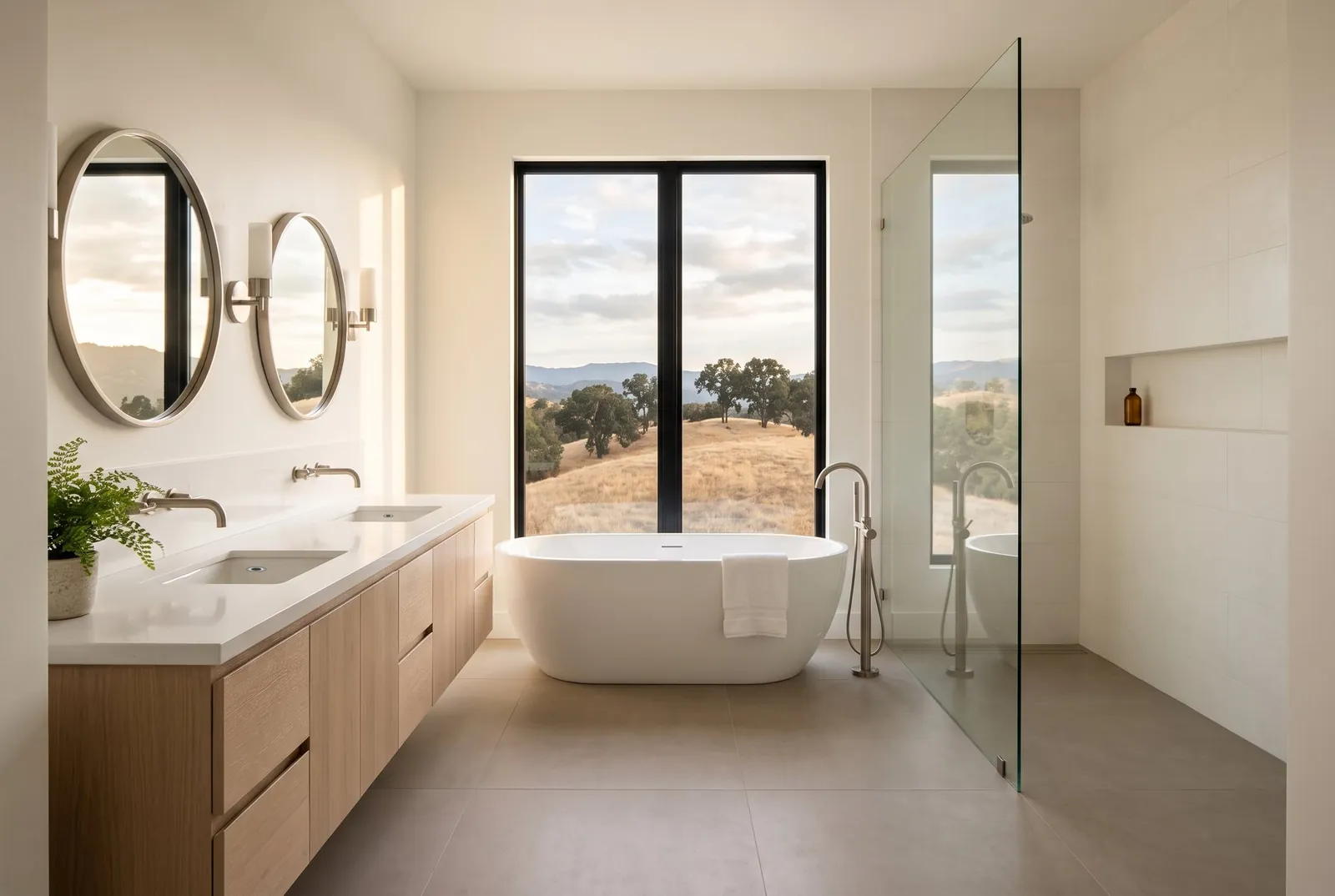A finished primary bathroom with a freestanding tub under a window and a walk-in shower behind clear glass